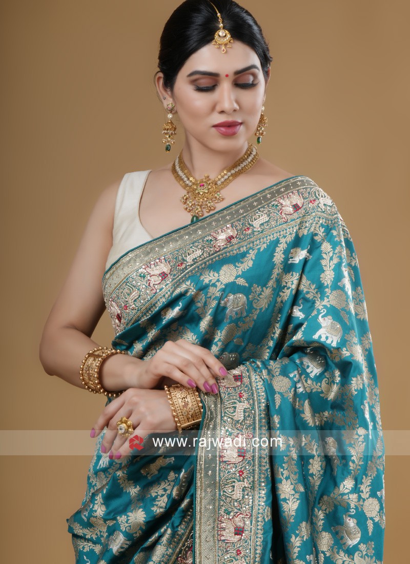 by Greg Rutkowski The Indian bride looked gorgeous in her Blue sari  accessorized with a gold Lakshmi Haram necklace and matching earrings