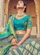 Turquoise Woven Floral Embroidered A Line Silk Lehenga Choli