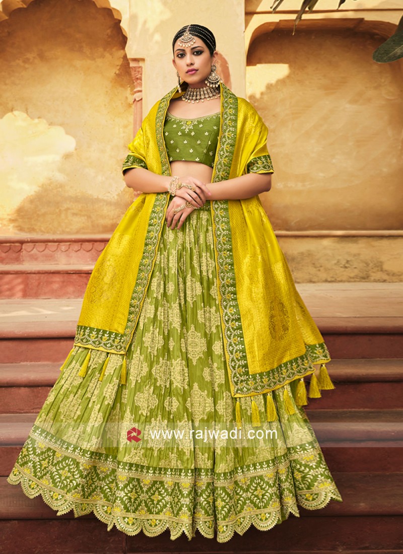 Photo of A bride in green lehenga with her groom